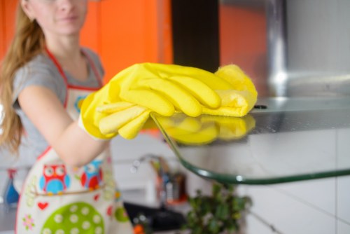Local technician treating stains on a three-seater sofa